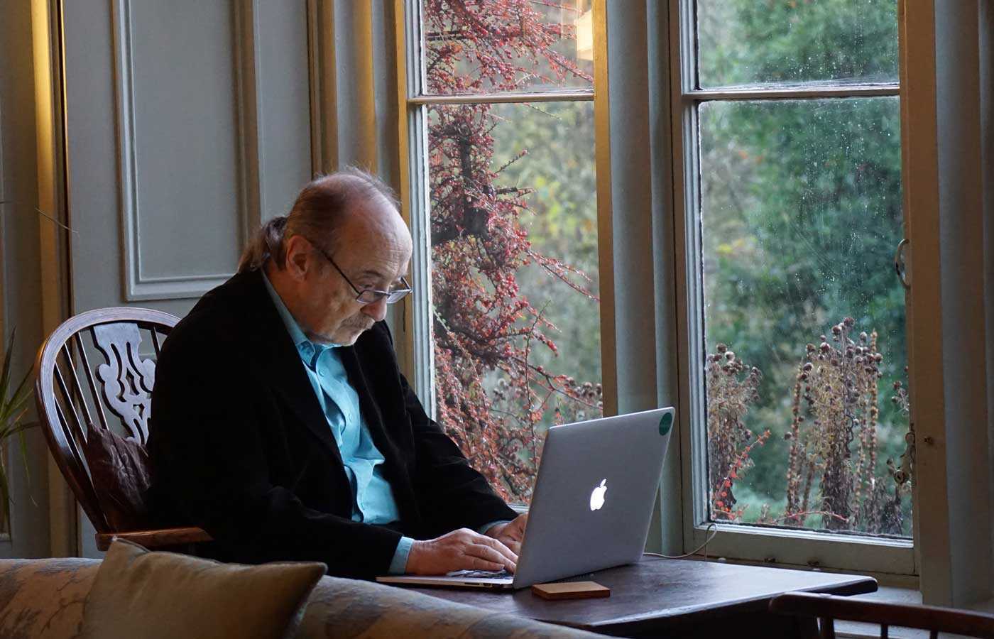 Image of an old man working on a laptop